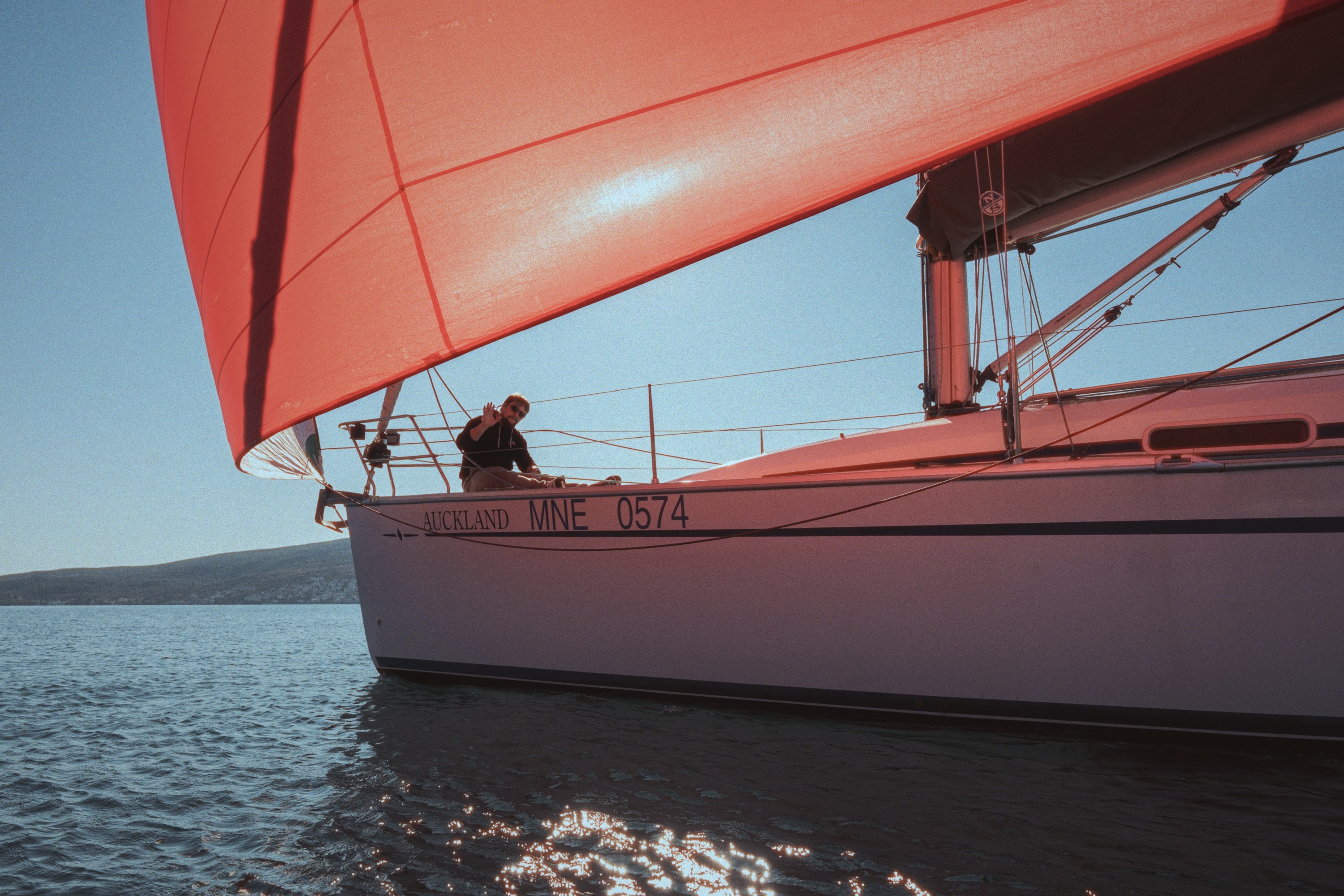 Sailing yacht with red spinnaker in Montenegro